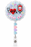 ICU RN heartbeat decoden cream badge reel on a white background