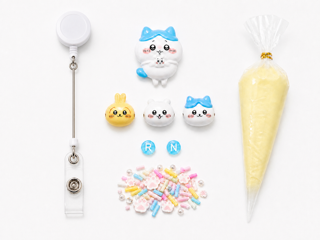 Mini Blue Cat RN DIY badge reel kit with character charms, letters, pastel fillers and cream glue on a pure white background