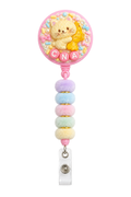 Mini CNA cat and banana decoden badge reel with pastel pom-pom beads on a pure white background
