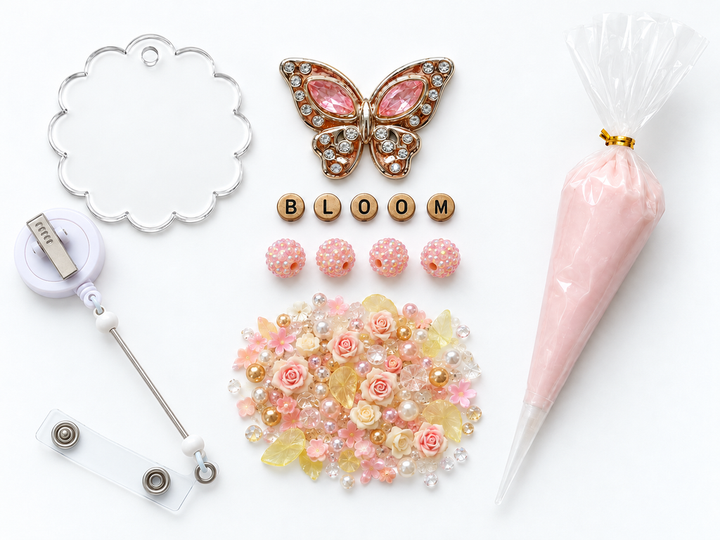 BLOOM butterfly DIY badge reel kit laid out with peach cream, gold round letters and four pink rhinestone beads