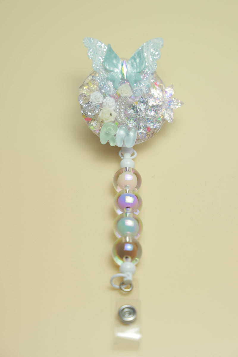 Crystal butterfly badge reel on a pale yellow background