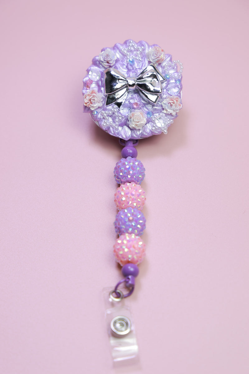 Purple crystal bow badge reel