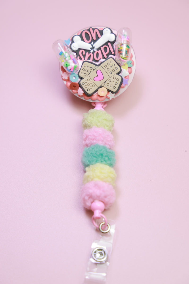 Pink pom-pom radiology badge reel
