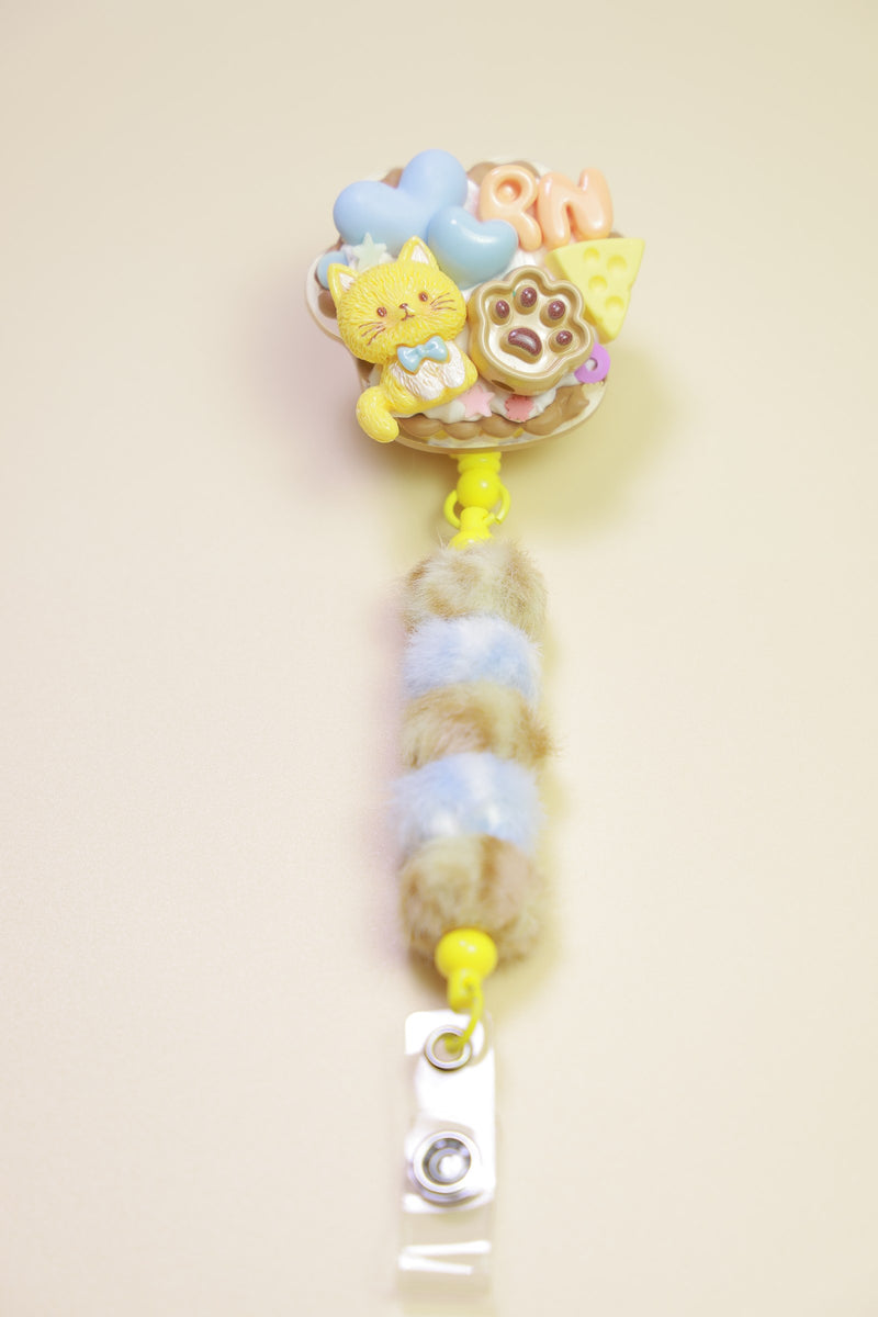 Pastel character badge reel on a pale yellow background