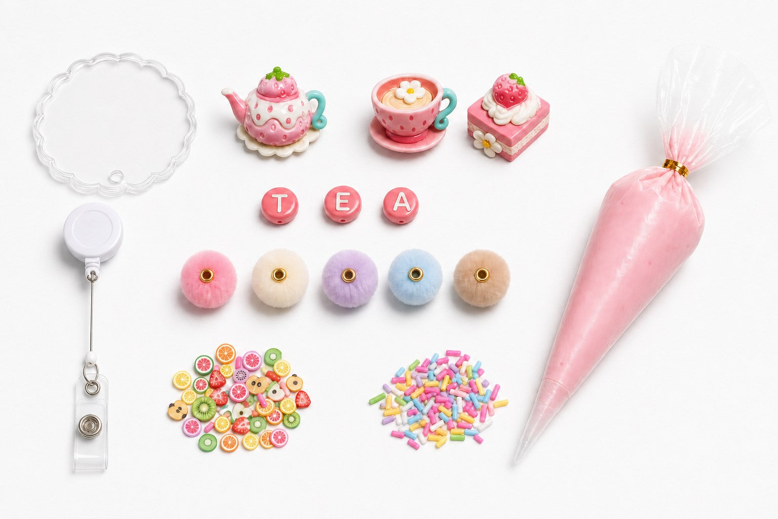 Strawberry Tea Party DIY badge reel kit contents with charms, TEA letters, beads, fruit slices, sprinkles, and pink cream glue